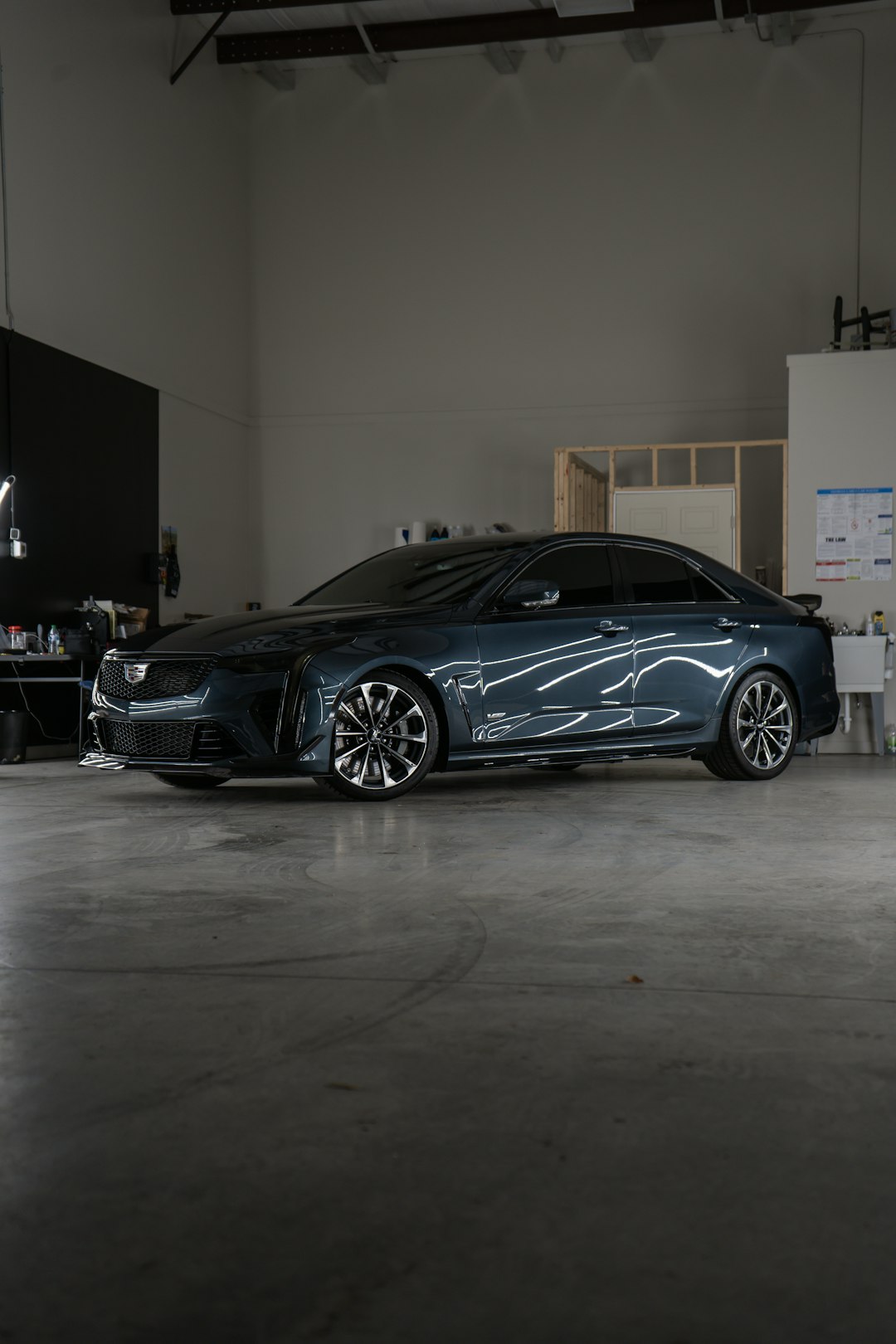 a-car-parked-inside-of-a-garage-next-to-a-wall-kw1dkzzw8yy